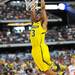 Michigan sophomore Trey Burke makes an easy basket after stealing the ball from Florida junior Scottie Wilbekin during the first half at Cowboys Stadium on Sunday, March 31, 2013. Melanie Maxwell I AnnArbor.com